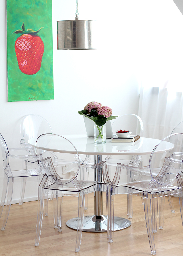 dining area in all white + louis ghost chair